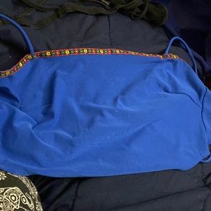 Not sure tank top. Skinny strap ties in back with tiny design. Blue. Size XS.